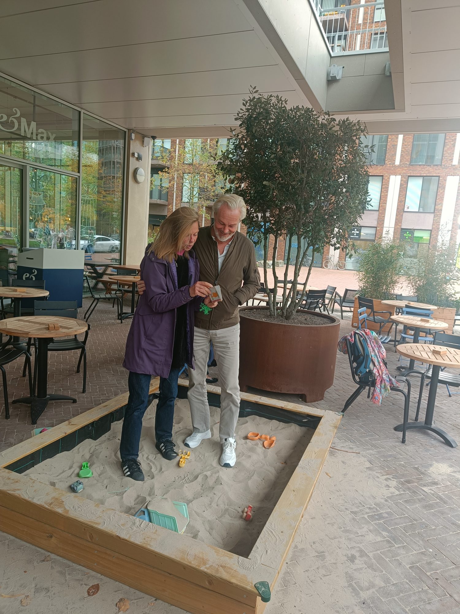 Two people talking over a coffee on a café terrace